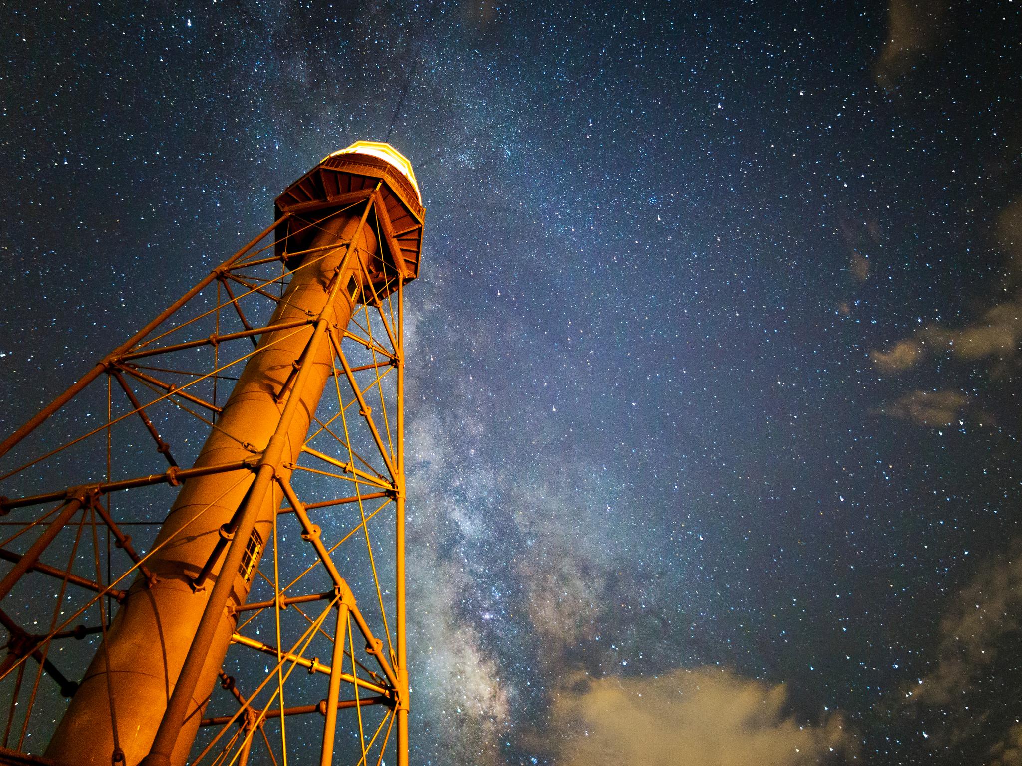 Sanibel Lighthouse underneath a starry night sky. Picture credit [Noel Benadom](https://commons.wikimedia.org/wiki/File:Lighting_the_Stars.jpg) licensed under [CC BY-SA 3.0](https://creativecommons.org/licenses/by-sa/3.0/)